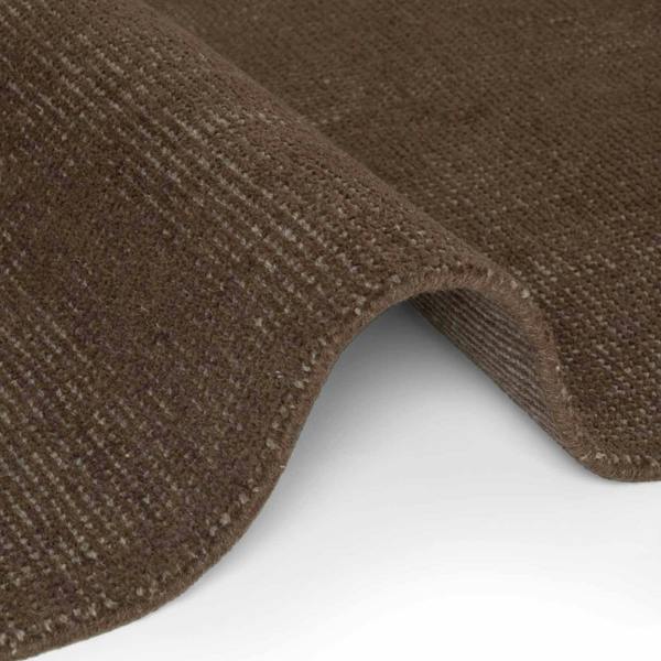 Brown textured carpet roll on a white background