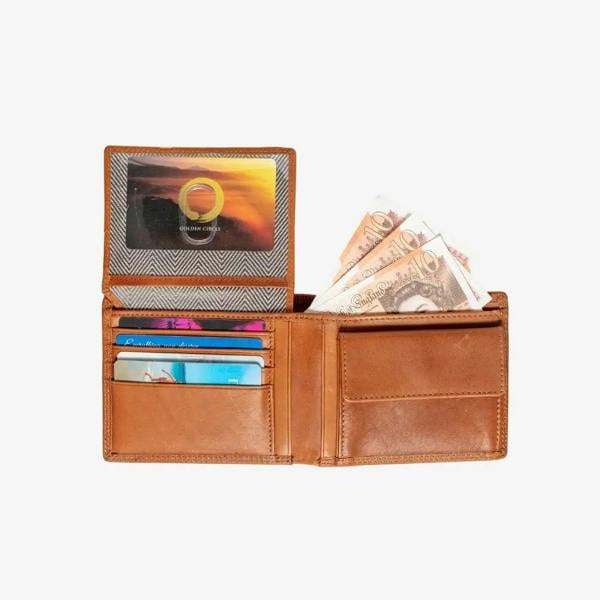 Tan leather wallet with cards and money on a white background