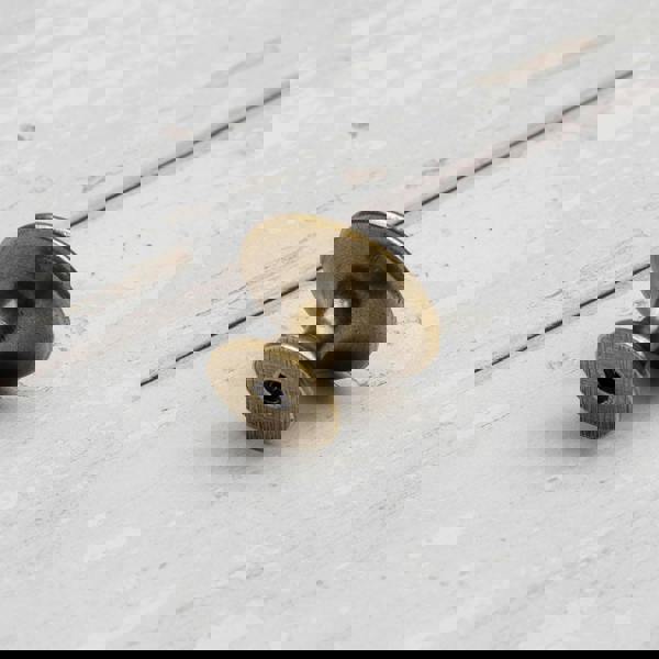 An antique brass round circular cabinet knob 