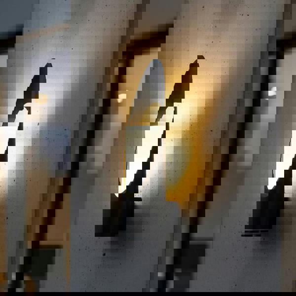 black external wall lantern mounted on a concrete wall outside a modern house 