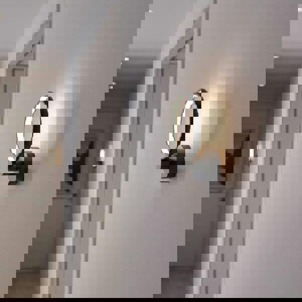 Black LED indoor wall lamp in a hallway of a modern home