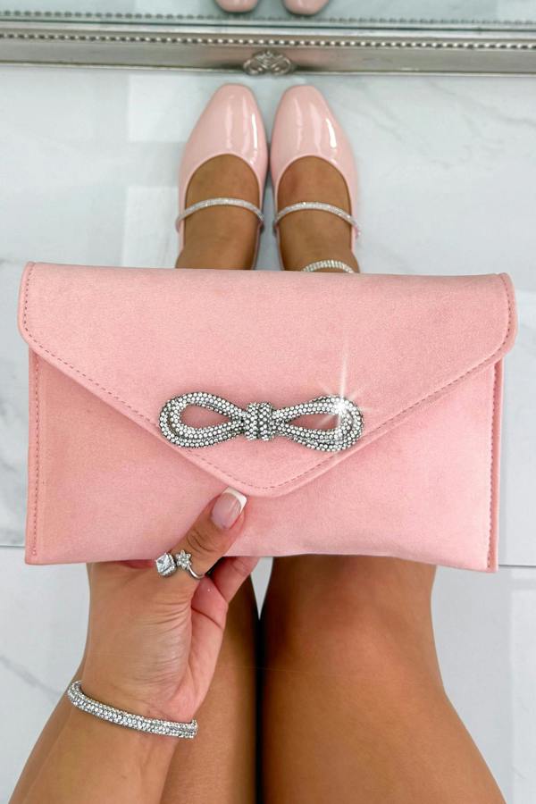 Crystal Bow Embellished Faux Suede Clutch Bag Baby Pink perfect for occasionwear with a luxe faux suede finish and statement bow detail.