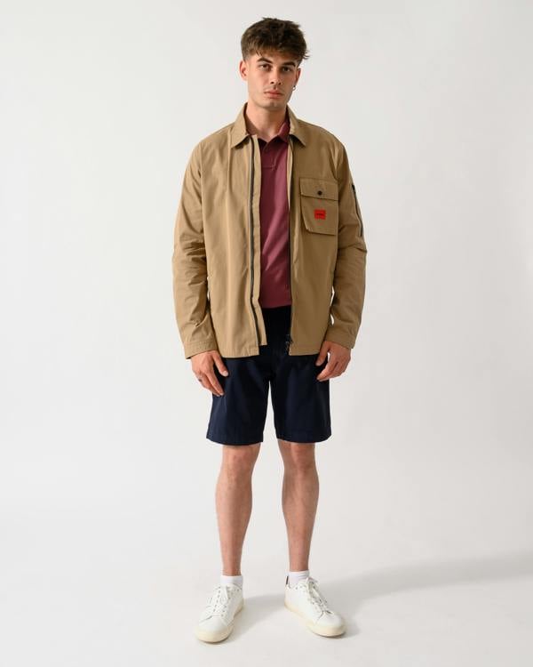 full length shot of a model wearing a HUGO Emmond Mens Zip Overshirt in Beige Overflow 928