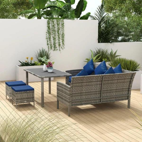Rattan outdoor dining corner set with dark blue cushions and square glass-top table