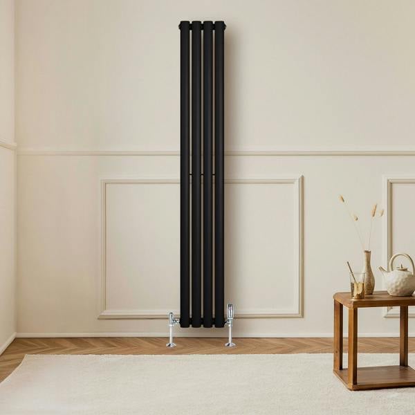 Sleek black oval single column radiator, 1600 x 240mm, mounted on a light wall, complemented by wooden flooring and a stylish table
