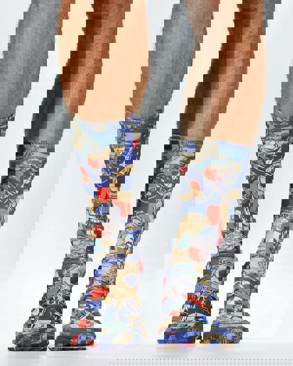 Colorful patterned socks worn by a person on a white background