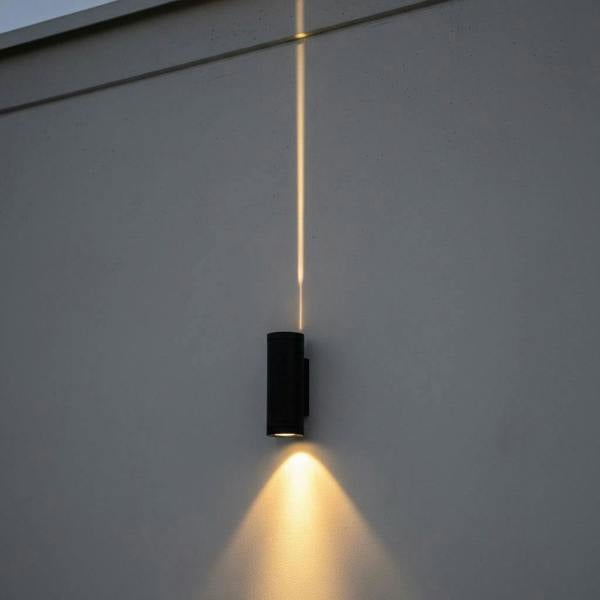 black up down light mounted on the exterior wall of a modern building