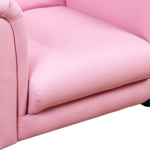 Pink seat cushion and arm join on kids sofa chair, smooth padded upholstery.