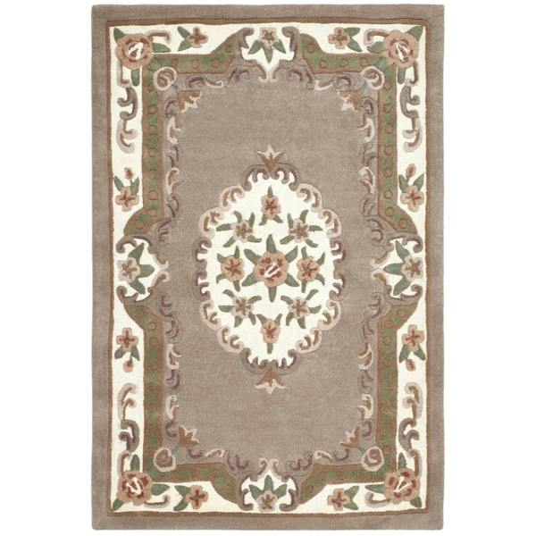 Decorative rug with floral pattern and border on a plain background