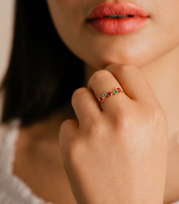 Young woman wearing the Hafeez Jewellery Warda Topaz and Emerald Ring