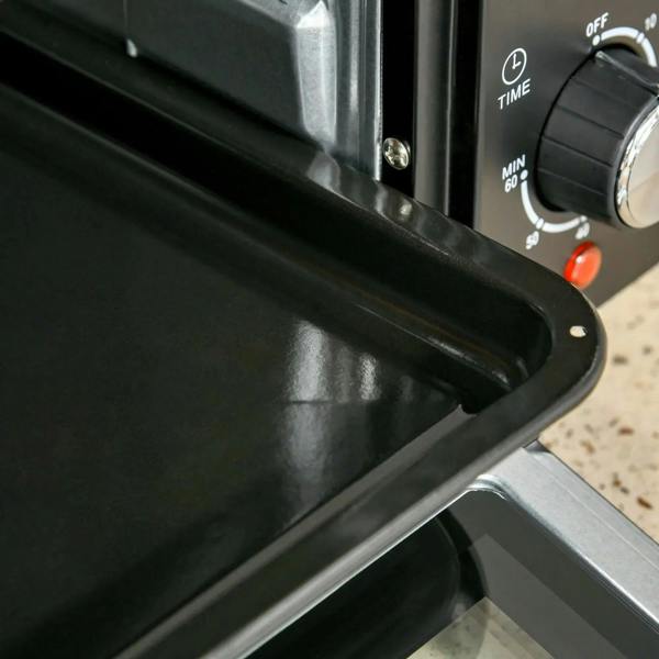 Black oven door latch area with power indicator and control dial on front panel