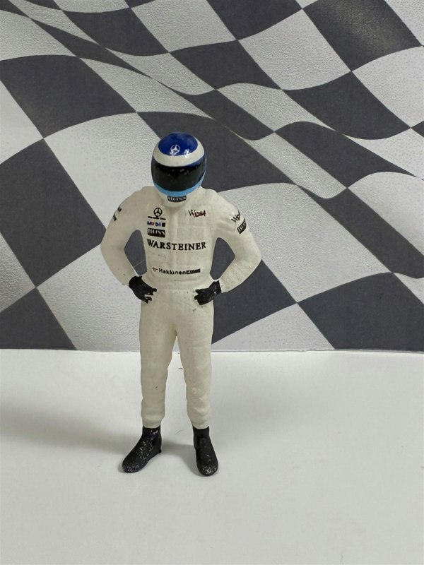 a toy figure of a race car driver