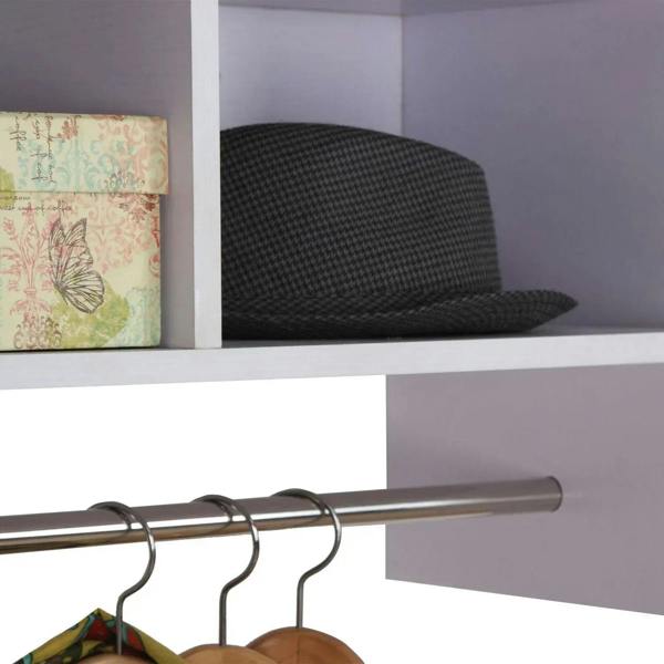 Close-up of metal hanging rail with coat hangers under a white storage shelf
