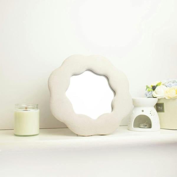 Stone-colored plush flower mirror with oval center cutout