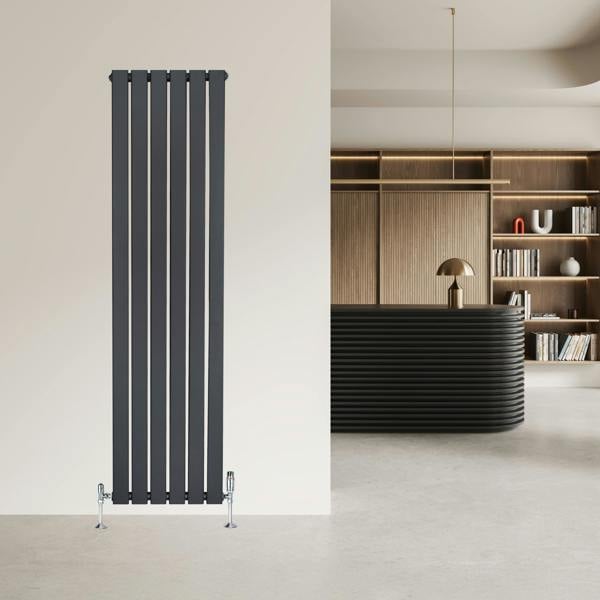 Flat single column radiator in anthracite grey, featuring vertical slats and a sleek design, mounted on a light wall in a modern interior