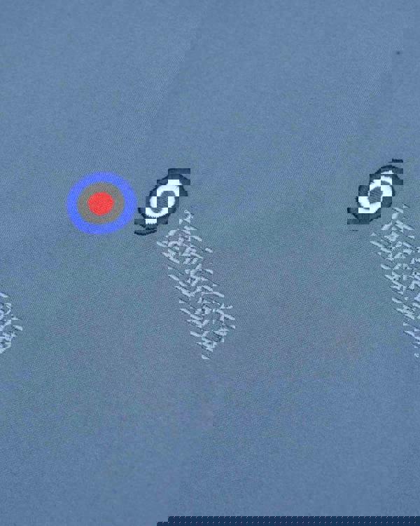 Lambretta Mens ShowerProof Classic Harrington MOD Scooter Jacket Coat, close-up of the embroidered Lambretta logo and target emblem on light blue fabric.