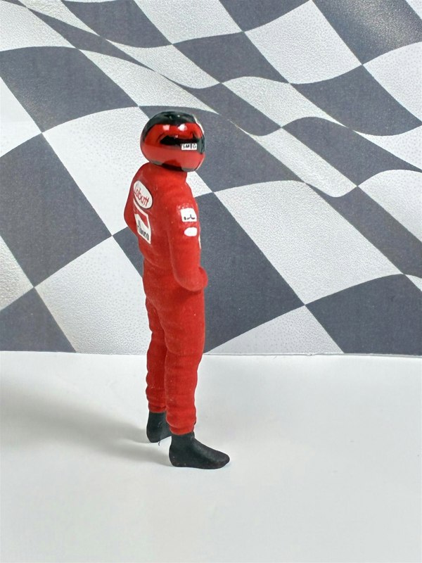 a toy figure in a red suit