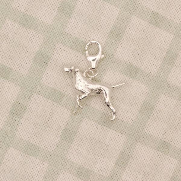 Silver Pointer dog charm on a checkered fabric background