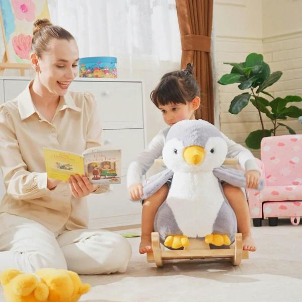 Plush penguin rocking horse with blue seat cushion, backrest, and light wood curved rockers