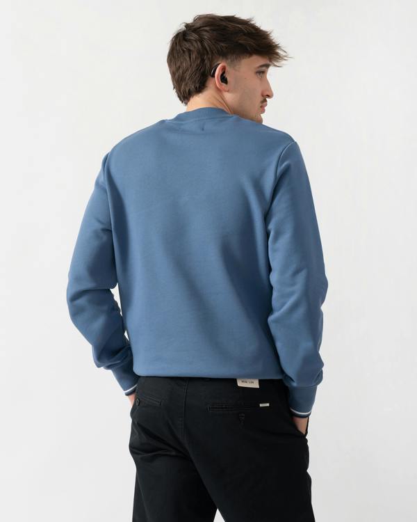 back shot of a model wearing a Fred Perry Mens Crew Neck Sweatshirt in Ace Blue with Snow White & Tennis Blue trim