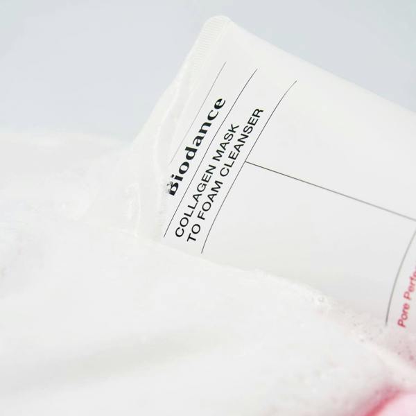 Stretchy, gelato-like sticky white gel texture of Biodance Collagen Mask To Foam Cleanser transforming into a rich lather with water at Atelier De Glow UK.