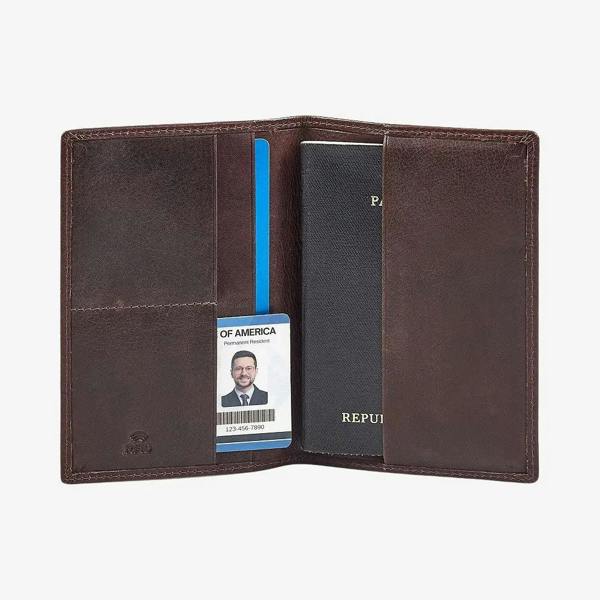 Brown leather passport holder with a passport and card holder on a white background