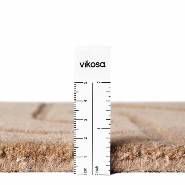Measurement of vikosa carpet fibers with a ruler showing thickness.