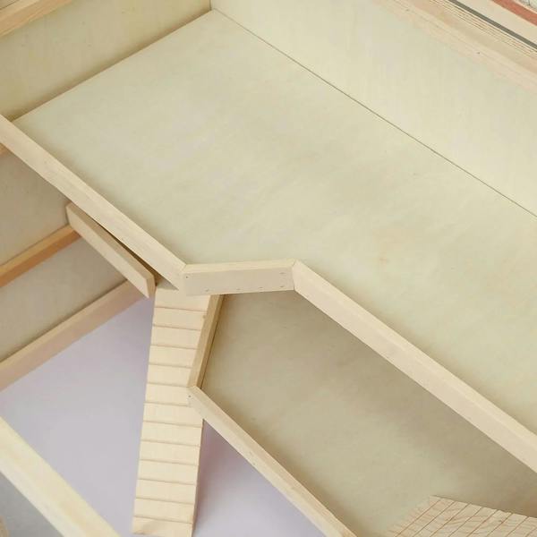 Wooden hamster cage interior with ramp, ladder-like steps, and platform base
