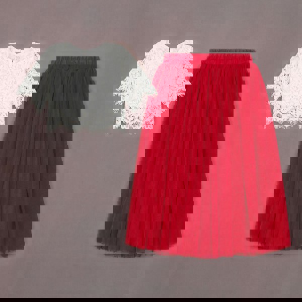 White lace top and red skirt on a gray background