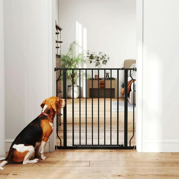 Black dog gate in a doorway with vertical bars and pressure-mounted brackets