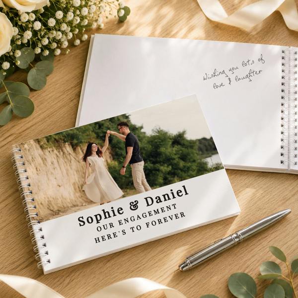 Personalised Photo Upload Guest Book showing custom cover for Sophie & Daniel's Engagement and an open page with handwritten message by Abode Home & Gifts