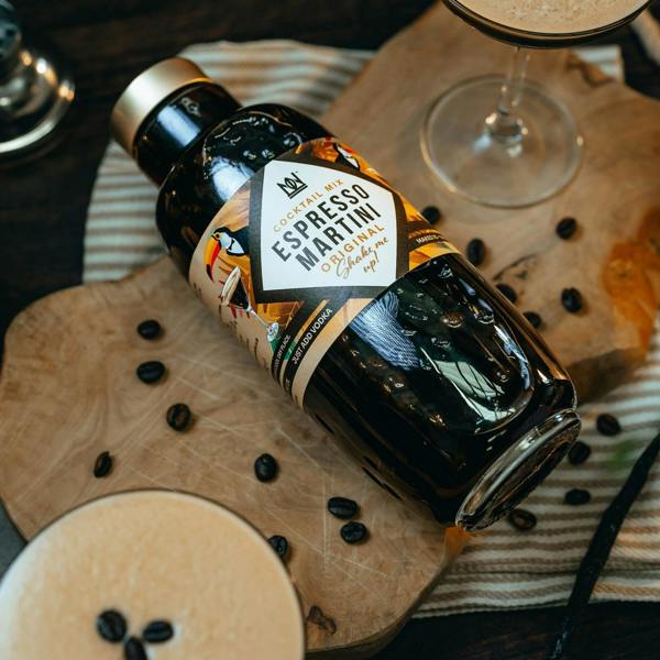 Natural & Noble Espresso Martini Cocktail Kit Laying Flat, Surrounded by Coffee Beans and Martini Glasses