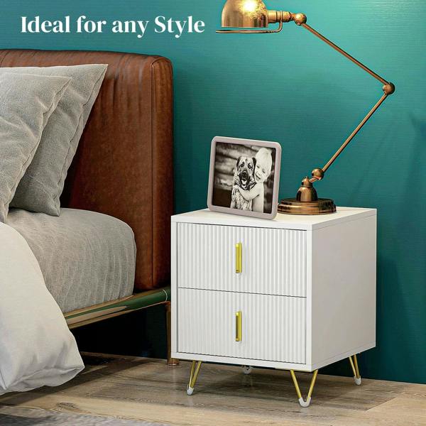 White two-drawer chest nightstand with ribbed doors, gold-tone pulls, and gold legs beside a bed