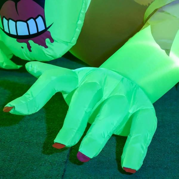 Green inflatable zombie ghost legs and hands on the ground with LED illumination