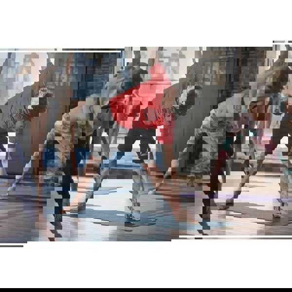 Yoga class doing a yoga pose on Reebok 4mm Yoga Mats