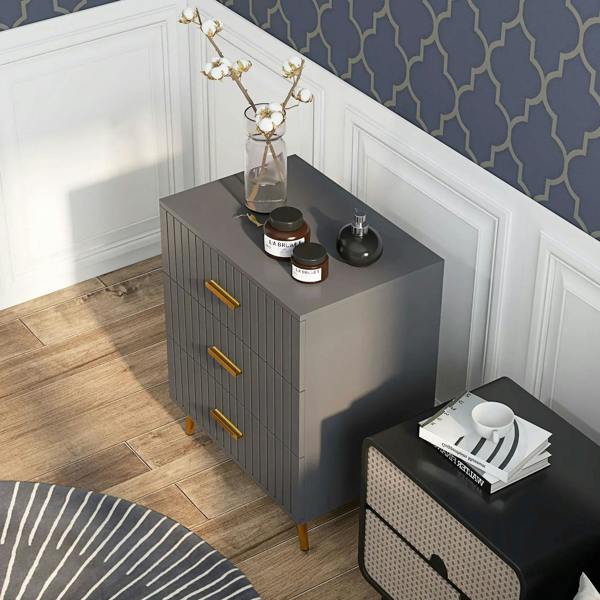 Dark grey three-drawer dresser with embossed vertical line pattern and gold-tone bar handles