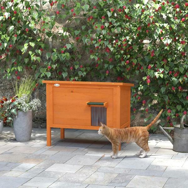 Orange wooden outdoor cat house with side entry opening and raised legs