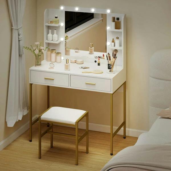 White lighted vanity desk with mirror and drawers, styled with bottles and a cushioned stool