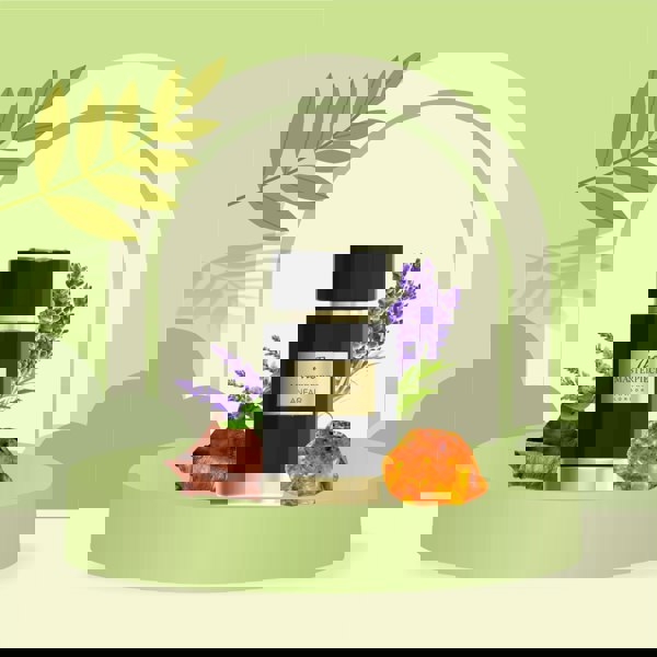 Black perfume bottle labeled 'Anfar The Masterpiece' with lavender flowers on a green background