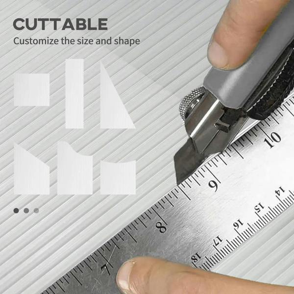 Clear twin-wall polycarbonate panel being cut with a utility knife and metal ruler