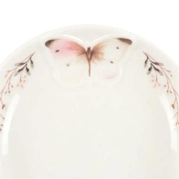 Butterfly trinket dish close-up with central pink butterfly and delicate floral border