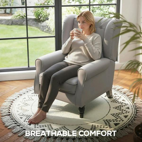 Light grey wingback armchair with button-tufted back and upholstered seat