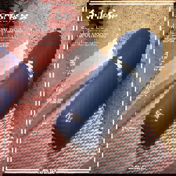 A blue ION8 travel flask lies on a striped cloth beside sunglasses on sand Text: "On the Go Enjoy your beverages in style and sustainability anywhere anytime Easy grip 100% leak proof 230 x 85 mm"