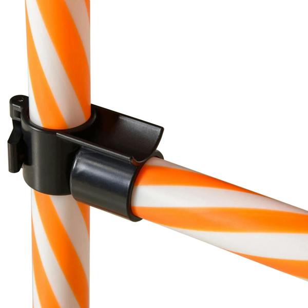 Black plastic clamp connector securing orange-and-white striped agility poles together