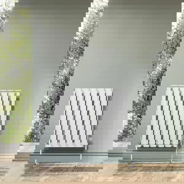 White oval single column radiator, 600 x 780mm, featuring sleek vertical lines and chrome valves, set against a soft green wall