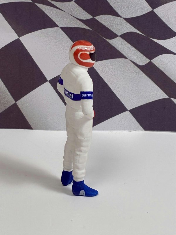 a toy figure of a race car driver
