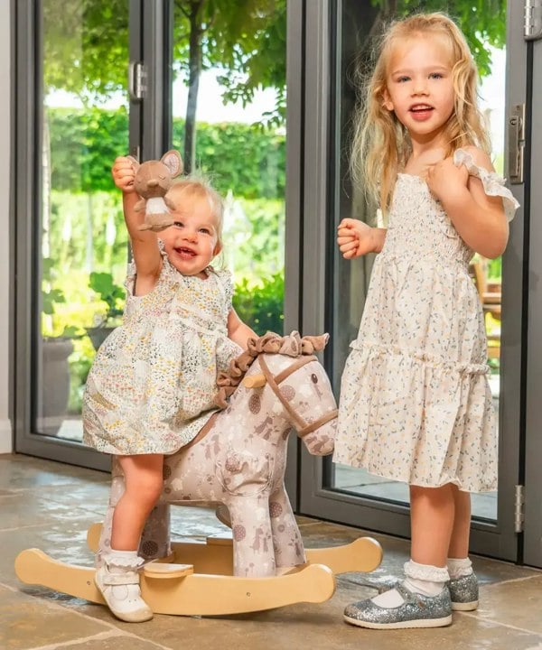 Girls playing with rocking horse