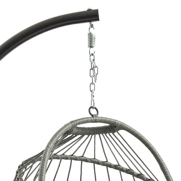 Grey rattan hanging egg chair with a curved shape, suspended from a sturdy metal frame, showcasing intricate weaving and a cozy design