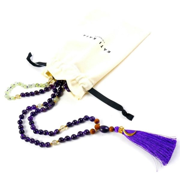 Kati Kaia amethyst mala necklace with purple beads and tassel displayed with white drawstring pouch