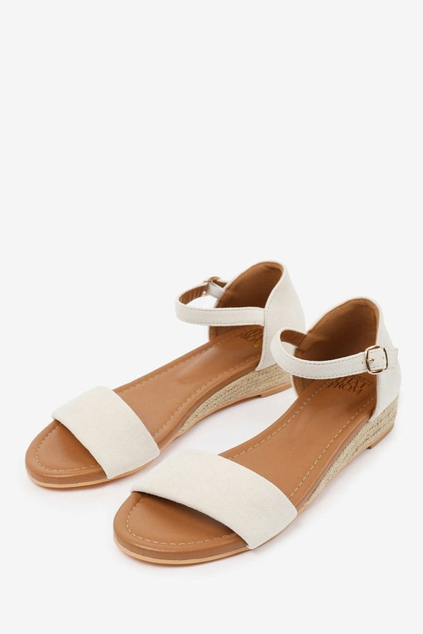 Where's That From Eleanor Wide Fit Low Wedge Shoes With Adjustable Ankle Strap in Cream Suede